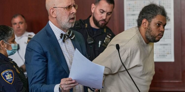 Randy Santos is humped over in a New York City Courtroom as an accompanying attorney argues to the court on May 28, 2026.