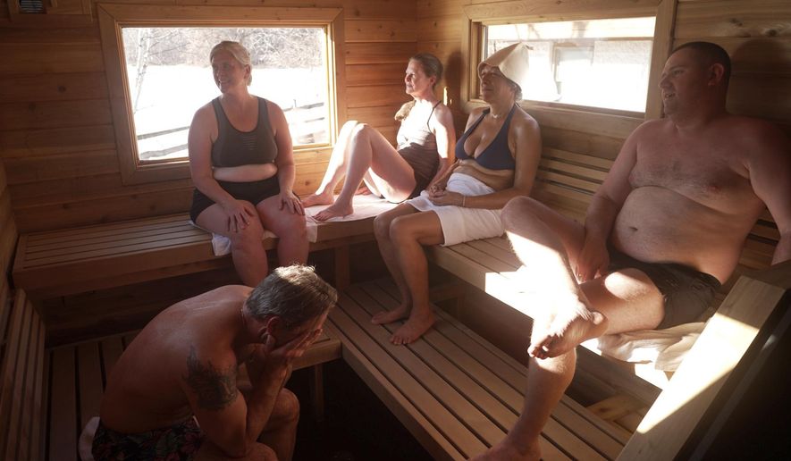 Sauna enthusiasts Jeff Tait, Emily Scribner-O’Pray, Darcy Sudderth, Miki Mosman and Igor Rudenko share a 75-minute session in a Saunable mobile sauna at Lebanon Hills Regional Park in Eagan, Minn., Sunday, Dec. 1, 2024. (AP photo/Mark Vancleave)