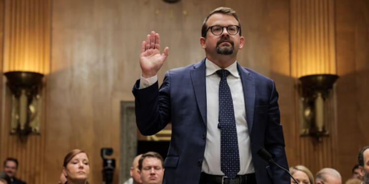 James Erdman III lifts his right hand as he takes the oath to testify to the Senate Homeland Protection and Government Affairs Committee on May 13, 2026.