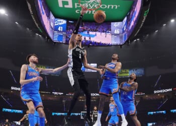Victor Wembanyama of the San Antonio Spurs dunks the ball between Chet Holmgren and Jalen Williams of the Oklahoma City Thunder during the first half in Game One of the NBA Western Conference Finals at Paycom Center on May 18, 2026, in Oklahoma City, Oklahoma.