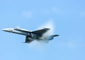 An F-18 Super Hornet at air show SIAF 2017 with a steam cone around the plane on Aug. 26, 2017.