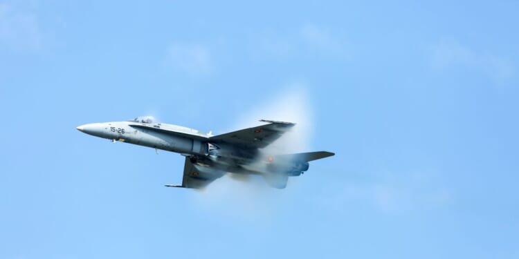 An F-18 Super Hornet at air show SIAF 2017 with a steam cone around the plane on Aug. 26, 2017.