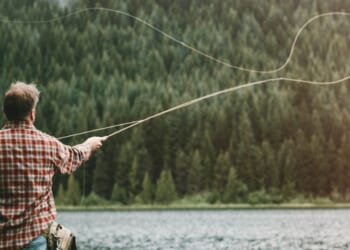 Scenes like this one of a man fly fishing in an Oregon lake may soon be a thing of the past, as animal rights actviists have gathered enough signatures to get a measure on November's ballot that would ban hunting and fishing.