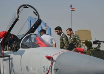 Military officials look at an Pakistan's JF-17 Thunder aircraft during International Defence Exhibition and Seminar 2022 at the Expo Centre in Karachi on Nov. 16, 2022.