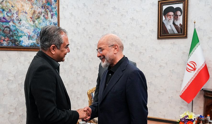 Iran's Parliament Speaker Mohammad Bagher Qalibaf, right, shakes hands with Pakistan's Interior Minister Mohsin Naqvi during their meeting in Tehran, Iran, Sunday, May 17, 2026. (Hamed Malekpour/ICANA via AP)