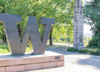 A statue showcasing the University of Washington’s emblem stands in the center of a paved walkway on the campus on June 15, 2023.