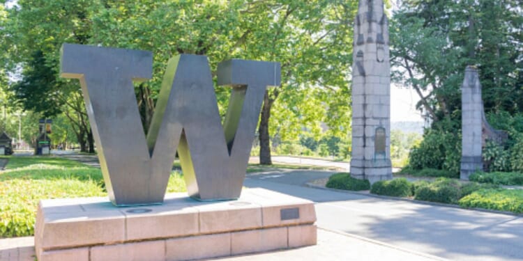A statue showcasing the University of Washington’s emblem stands in the center of a paved walkway on the campus on June 15, 2023.