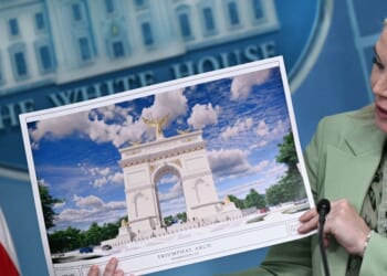 White House Press Secretary Karoline Leavitt shows an artist's rendering of President Donald Trump's planned Triumphal Arch during a press briefing in the Brady Briefing Room at the White House in Washington, D.C., on April 15, 2026.