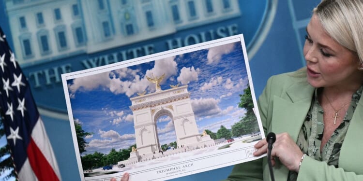 White House Press Secretary Karoline Leavitt shows an artist's rendering of President Donald Trump's planned Triumphal Arch during a press briefing in the Brady Briefing Room at the White House in Washington, D.C., on April 15, 2026.