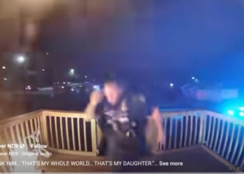 The officer kicked down the door before rushing into the burning home.