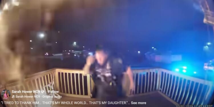The officer kicked down the door before rushing into the burning home.