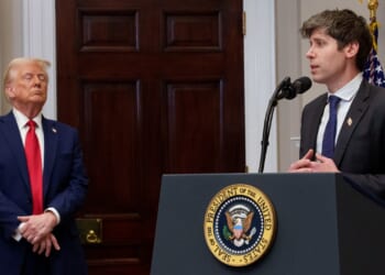 OpenAI CEO Sam Altman speaking at a podium in front of President Donald Trump