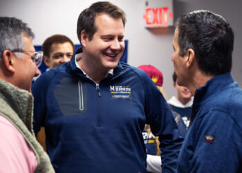 Republican Derek Merrin smiles as he talks with Bernie Moreno and Alex Triantafilou.