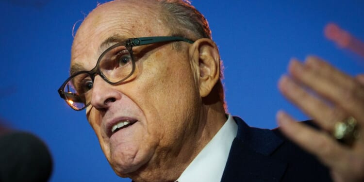 Rudy Giuliani gestures while speaking to reporters outside the E. Barrett Prettyman Courthouse on Dec. 11, 2023 in Washington, DC.