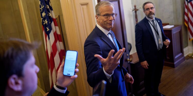 Senate Majority Leader John Thune, a South Dakota Republican, gestures pauses to speak to reporters Thursday as he walks into his office at the U.S. Capitol Building in Washington, D.C.