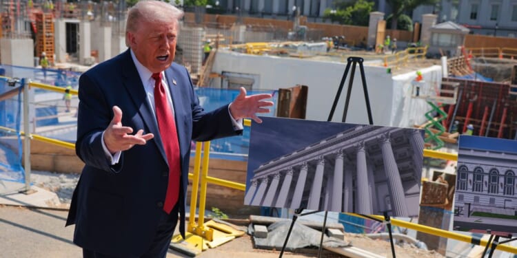 President Donald Trump speaks to the media Tuesday alongside posters of his proposed White House ballroom amid construction at the White House in Washington, D.C.