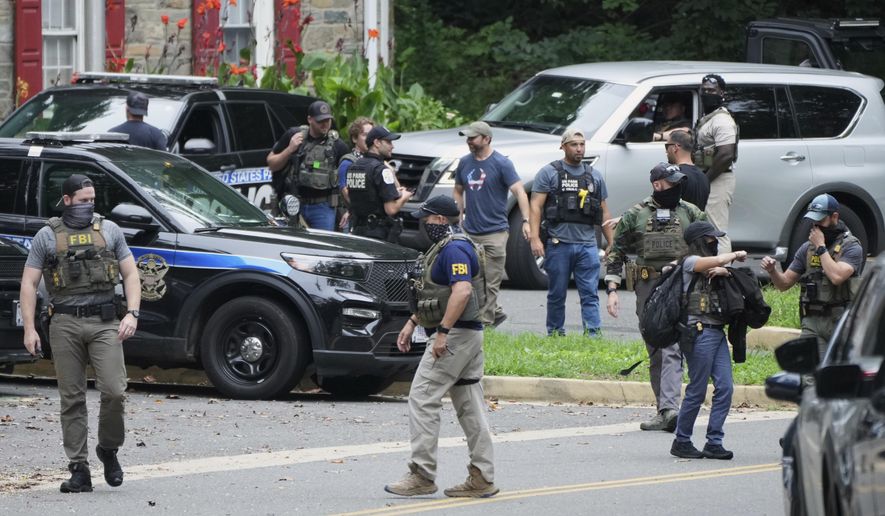 Officers from various federal agencies, including Homeland Security Investigations, FBI, Department of Homeland Security from the Boston Field Office, and U.S. Park Police, prepare for patrols at the U.S. Park Police Rock Creek Station, Thursday, Aug. 21, 2025, in Washington. (AP Photo/Jacquelyn Martin) ** FILE **