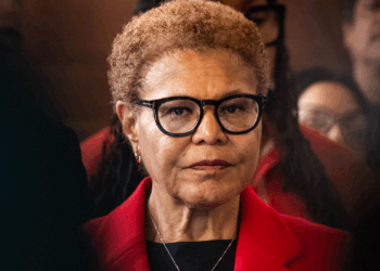 Karen Bass stands with a straight face.