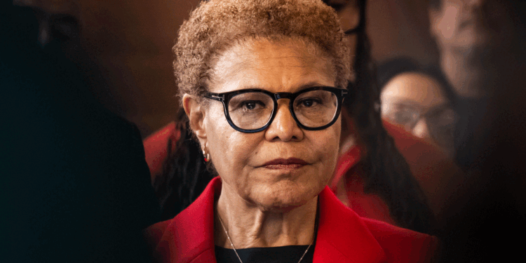 Karen Bass stands with a straight face.