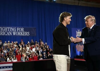 President Donald Trump is welcomed by New York Giants quarterback Jaxson Dart before delivering a speech about the economy at Rockland Community College Fieldhouse in Suffern, New York, on May 22, 2026.