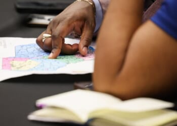 Two women examine the newly redrawn map for South Carolina on May 8, 2026.