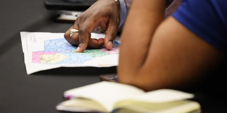 Two women examine the newly redrawn map for South Carolina on May 8, 2026.