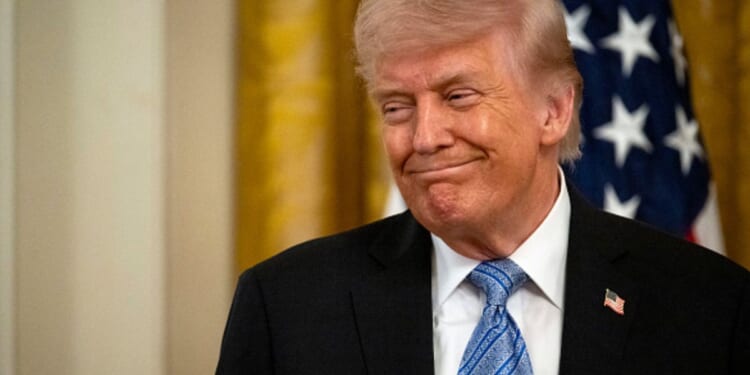President Trump stands and smiles in the East Room in the White House on May 4, 2026.