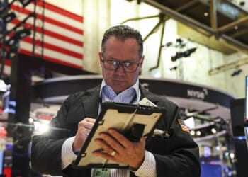 A trader working on the floor of the New York Stock Exchange