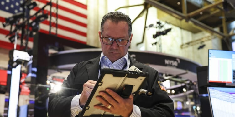 A trader working on the floor of the New York Stock Exchange