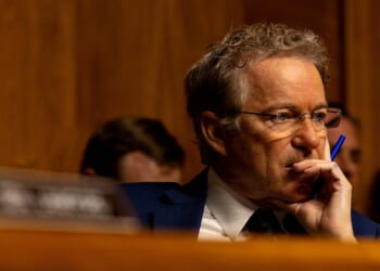 Sen. Rand Paul listening while seated