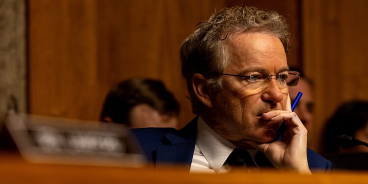 Sen. Rand Paul listening while seated