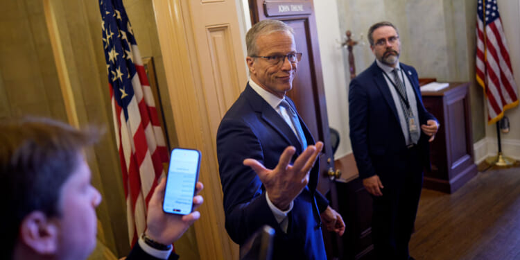 Senate Majority Leader John Thune (R-SD) gestures while speaking to reporters as he walks into his office at the U.S. Capitol Building on May 21, 2026 in Washington, DC.