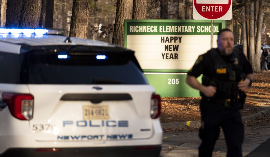 Police respond to a shooting at Richneck Elementary School, Friday, Jan. 6, 2023, in Newport News, Va. A shooting at a Virginia elementary school sent a teacher to the hospital and ended with “an individual” in custody Friday, police and school officials in the city of Newport News said. (Billy Schuerman/The Virginian-Pilot via AP) ** FILE **