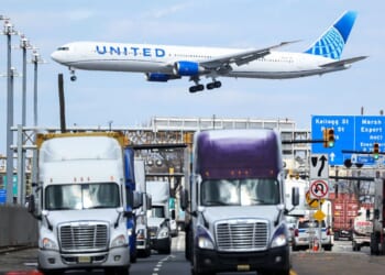 A United Airlines Boeing 767 passenger aircraft approaches Newark Liberty International Airport as trucks travel near the Port Newark Container Terminal in Newark, New Jersey, in a file photo dated April 8, 2025.