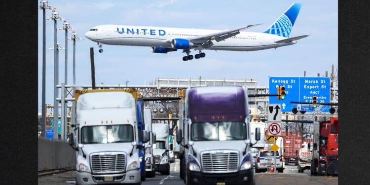 A United Airlines Boeing 767 passenger aircraft approaches Newark Liberty International Airport as trucks travel near the Port Newark Container Terminal in Newark, New Jersey, in a file photo dated April 8, 2025.