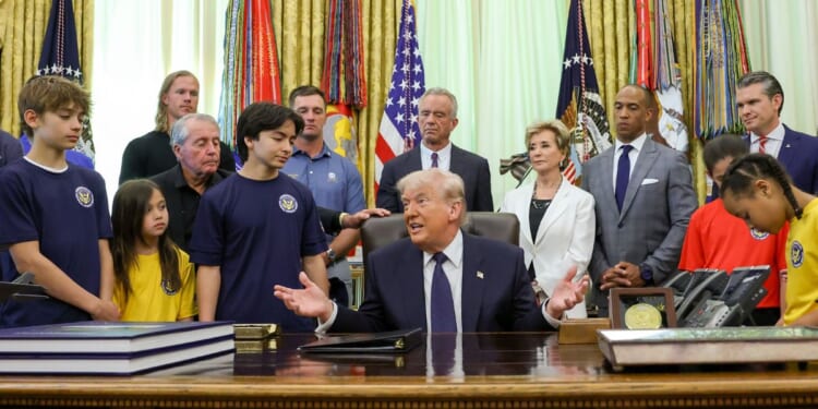 President Donald Trump is joined by, from left, Major League Baseball pitcher Noah Syndergaard, retired professional golfer Gary Player, professional golfer Bryson DeChambeau, Secretary of Health and Human Services Robert F. Kennedy Jr., Education Secretary Linda McMahon, Secretary of Housing and Urban Development Scott Turner, Secretary of War Pete Hegseth and young athletes during a proclamation signing Tuesday in the Oval Office of the White House in Washington, D.C. Trump signed a presidential memorandum restoring the Presidential Fitness Test Award, reintroducing a performance-based benchmark in physical education.
