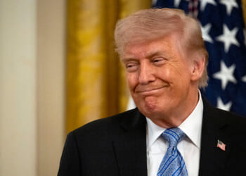 Trump smiles.