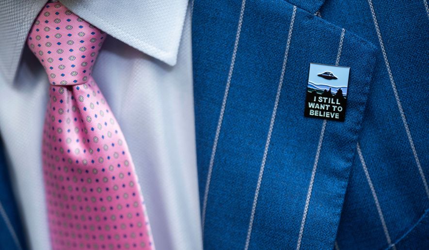 An audience member wears a UFO pin during a House Oversight and Accountability subcommittee hearing on UFOs, July 26, 2023, on Capitol Hill in Washington. (AP Photo/Nathan Howard, File)