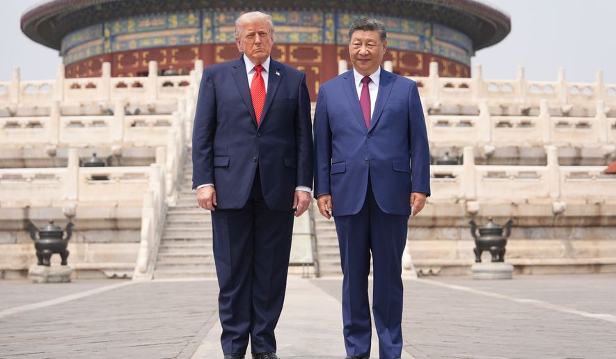 President Donald Trump, left, stands with Chinese President Xi Jinping at the Temple of Heaven on Thursday May 14, 2026, in Beijing. (AP Photo/Mark Schiefelbein)