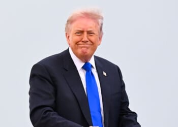 President Donald Trump smiles as he boards Air Force One on April 24, 2026 at Joint Base Andrews, Maryland.