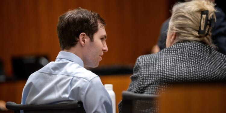 Tyler Robinson, left, speaks with his attorney Kathryn Nester in 4th District Court in Provo, Utah, on April 17.