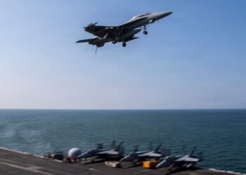 An F/A-18F Super Hornet flies over the flight deck of Nimitz-class aircraft carrier USS Abraham Lincoln in a file photo dated March 6 in the Mediterranean Sea.