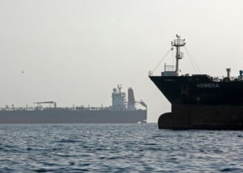 A ship remains anchored on May 16, 2026, in the Strait of Hormuz near Larak Island, Iran.