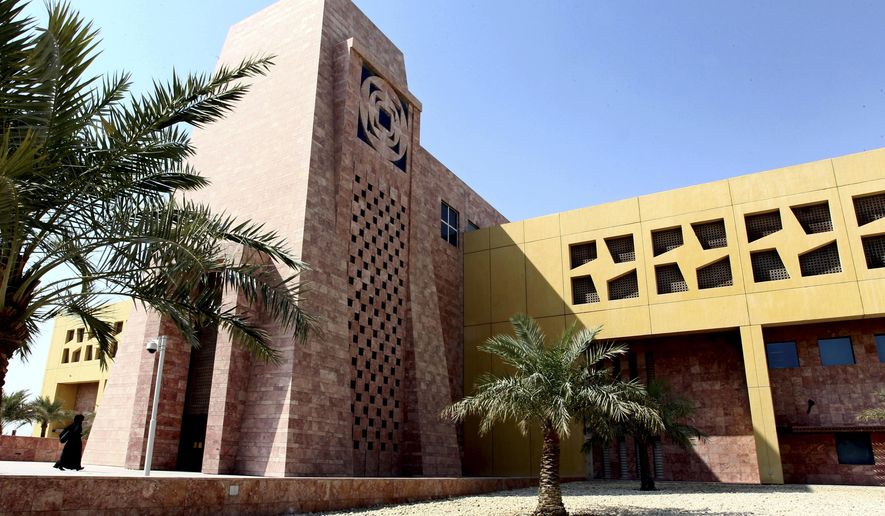 A Qatari student walks to a building in the Texas A&M University campus at Education City, on Tuesday, Oct. 18, 2011, in Doha, Qatar. Texas A&M University will close its 20-year-old Qatar campus by 2028, with board members noting “heightened instability" in the Middle East as a major reason to reconsider its presence in the country. (AP Photo/Osama Faisal, File)