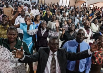 Christians raise their hands in worship at a church in Kampala, Uganda on Jan. 11, 2026.