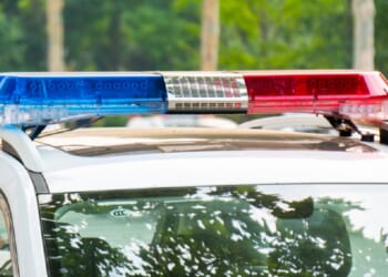 A law enforcement vehicle with lights flashing.