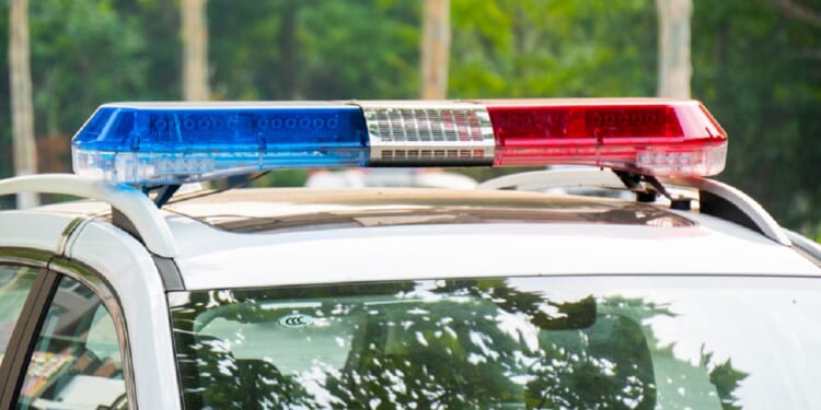 A law enforcement vehicle with lights flashing.
