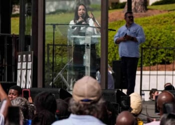 Rep. Alexandria Ocasio-Cortez, a New York Democrat, made a show of speaking from behind a bulletproof glass at a voting rights rally Saturday in Montgomery, Alabama.