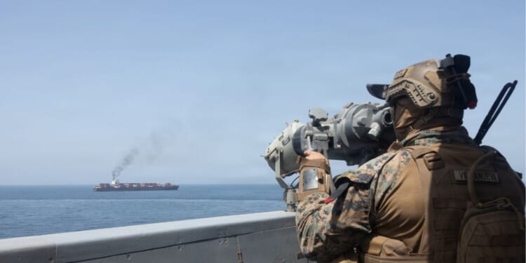 In this handout photo provided by U.S. Central Command, U.S. forces patrol the Arabian Sea near M/V Touska on April 20, 2026, after firing upon the Iranian-flagged vessel that the U.S. accused of attempting to violate the U.S. naval blockade of Iranian ports near the Strait of Hormuz.