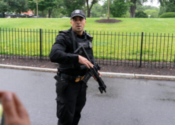 A Secret Service officer prevents journalists from leaving the White House on May 23, 2026.